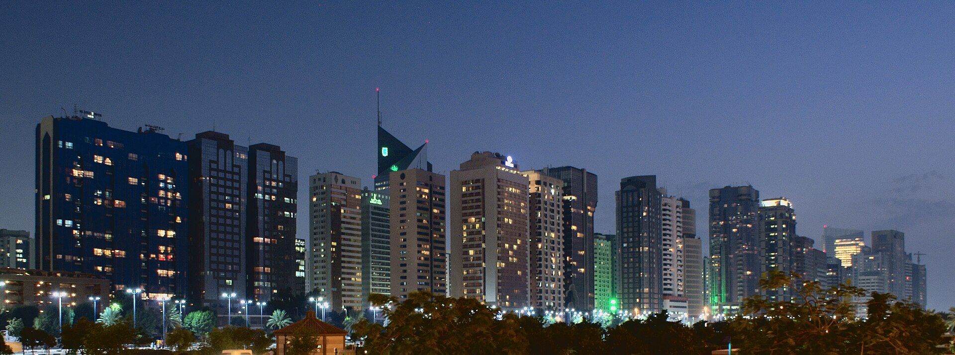 Abu Dhabi city skyline along the Corniche at dusk