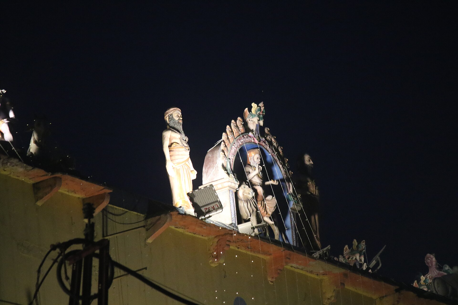 Aerial view of the lit ghats of Varanasi from the river, with thousands of diyas along the waterline