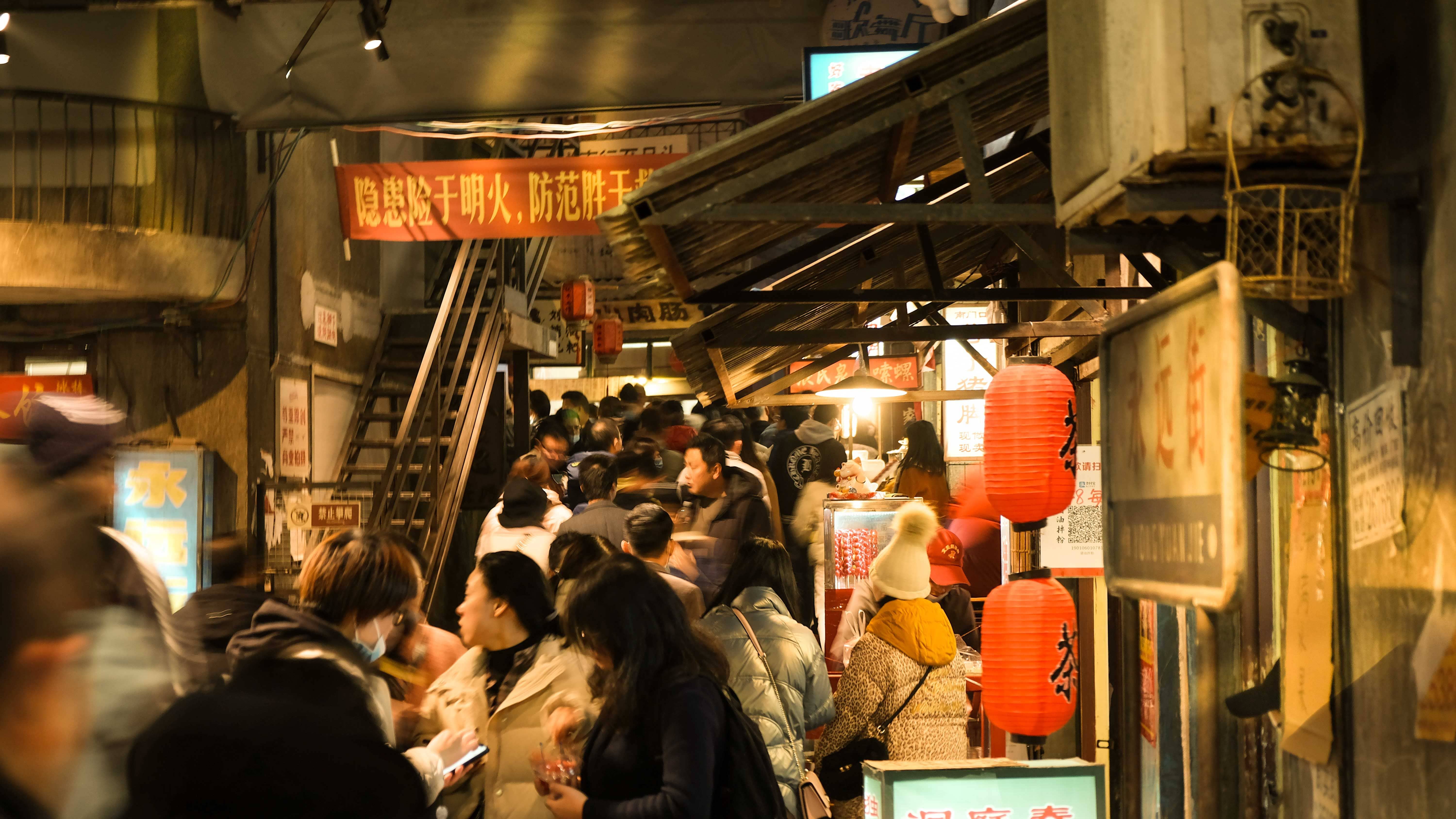 Yonghegong Lama Temple metro station entrance on Beijing Line 2 with crowds of visitors heading towards Ditan Park