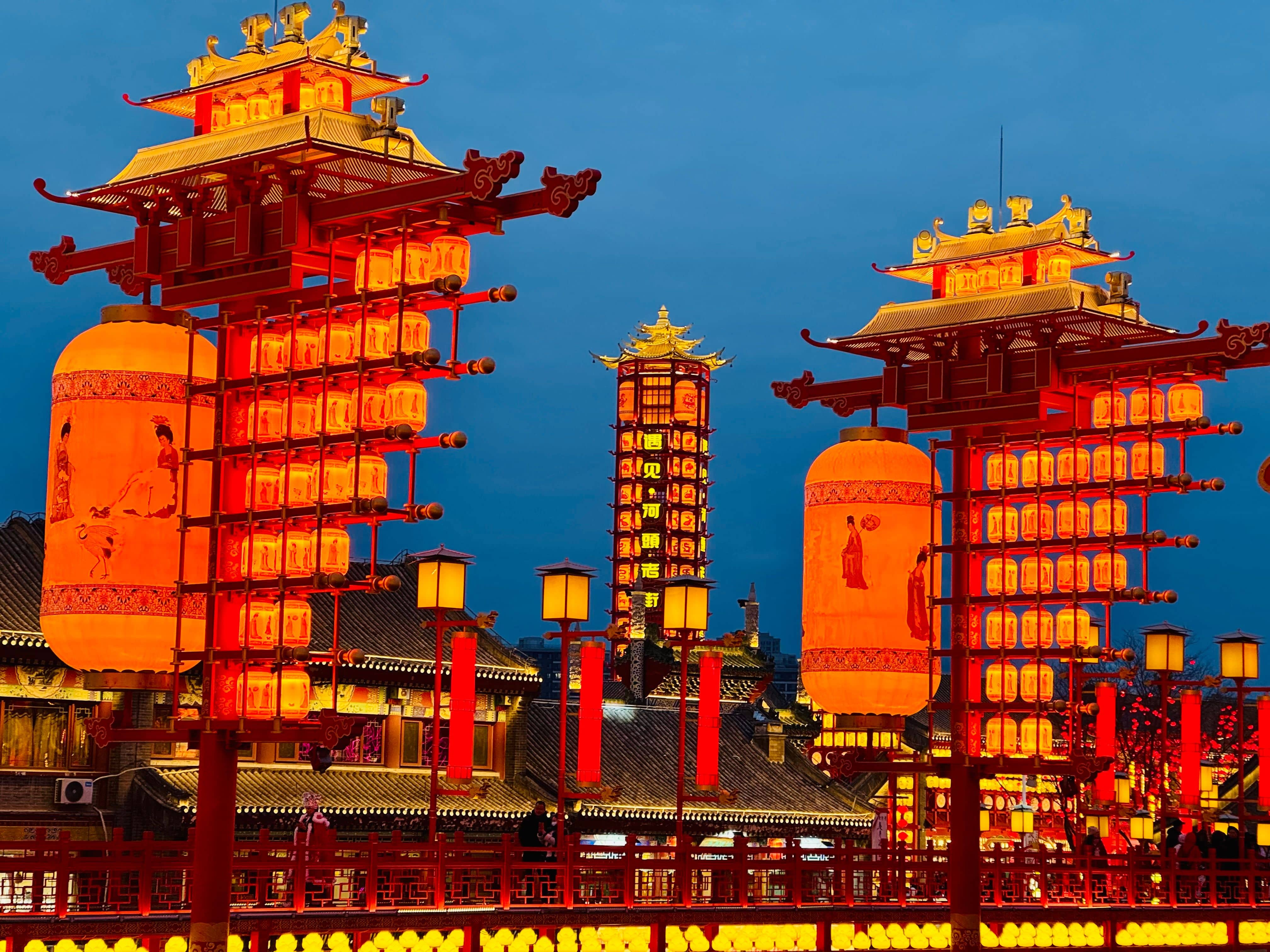 Red lanterns and a giant horse-shaped lantern installation glowing over the crowds at Yu Garden in Shanghai during the New Year lantern festival