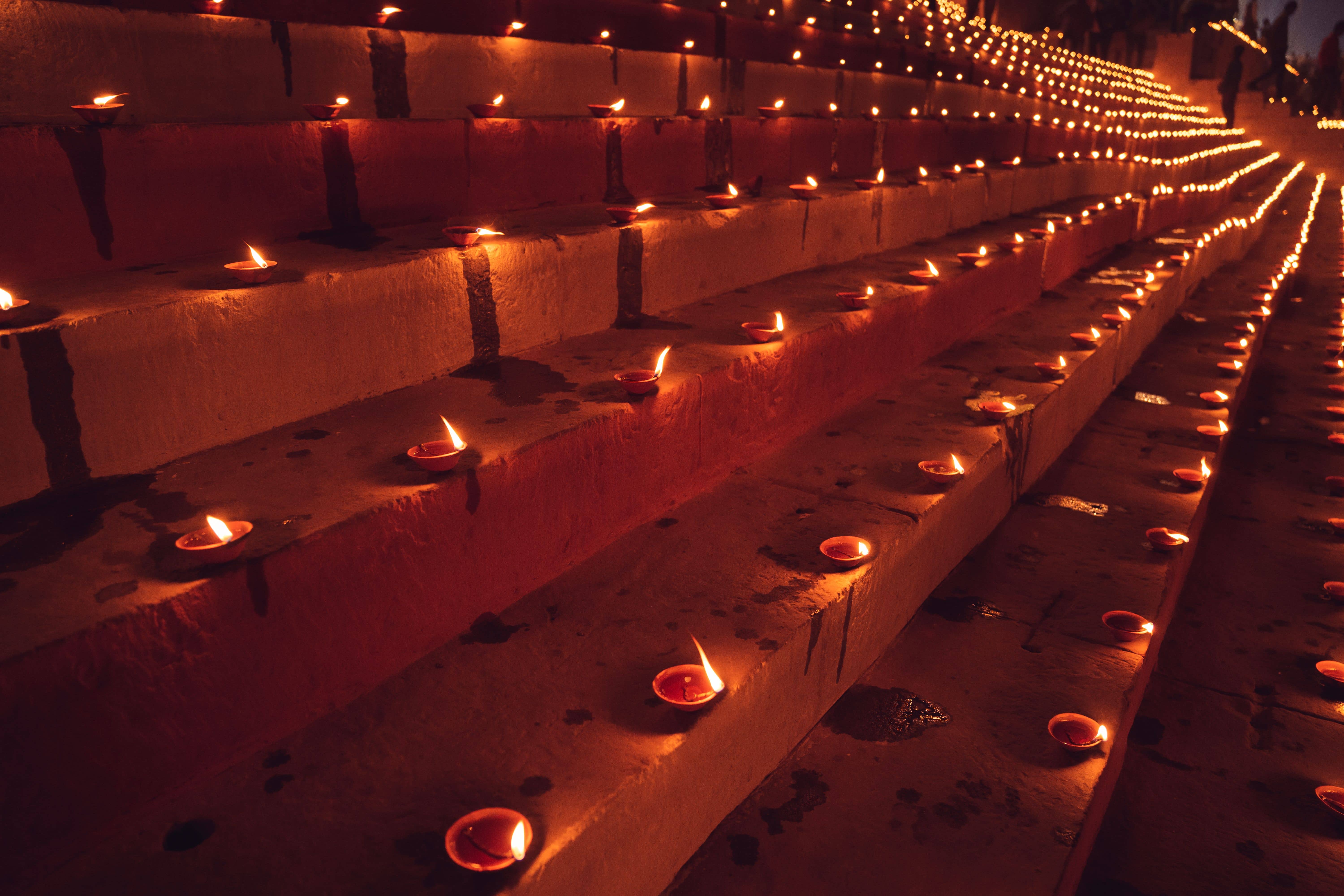 Priests with brass lamps performing the Ganga Aarti on the platforms of Dashashwamedh Ghat