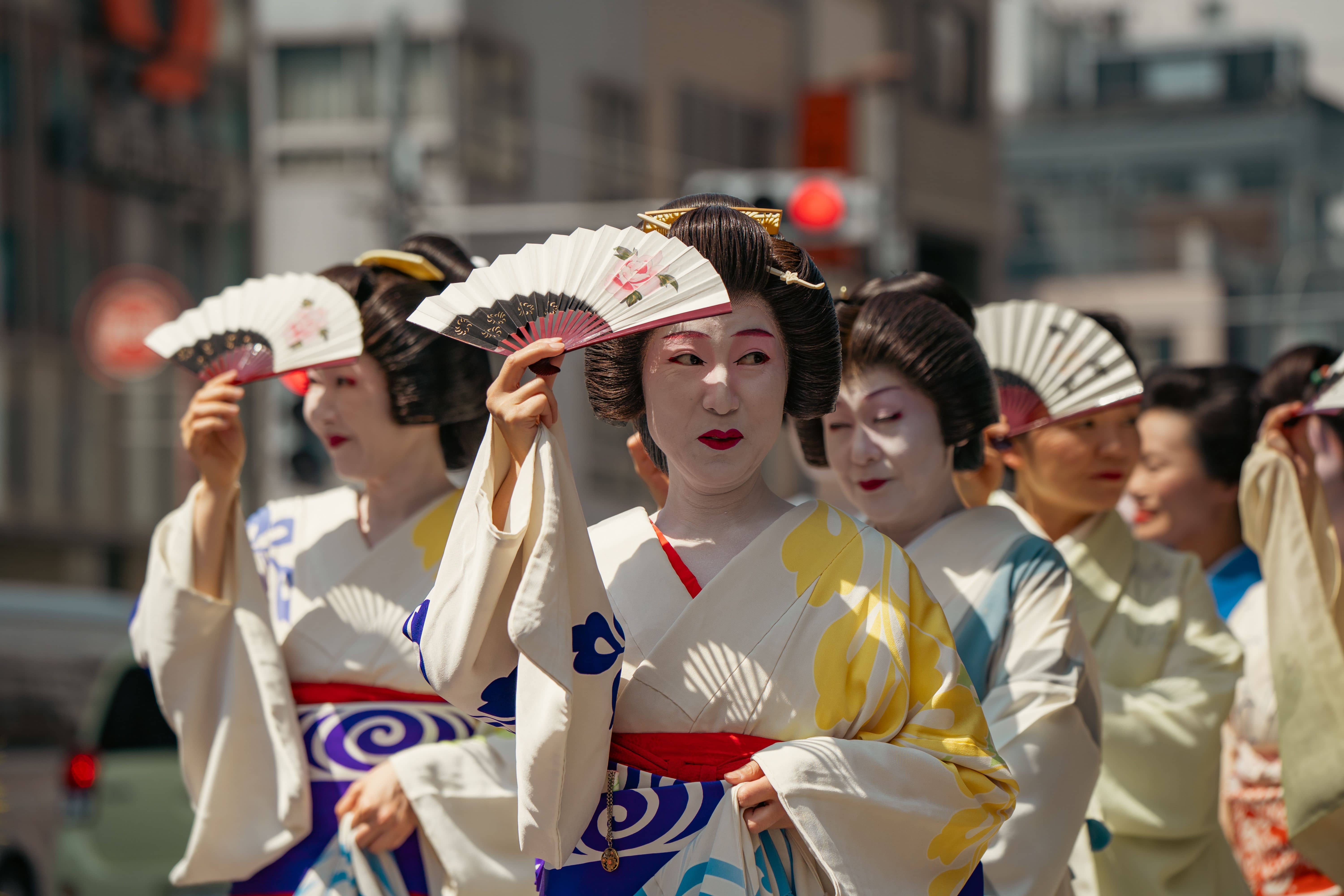 Hundreds of carriers in happi coats crowding the courtyard of Asakusa Shrine at dawn as one of the three great mikoshi is lifted during the Sunday miya-dashi