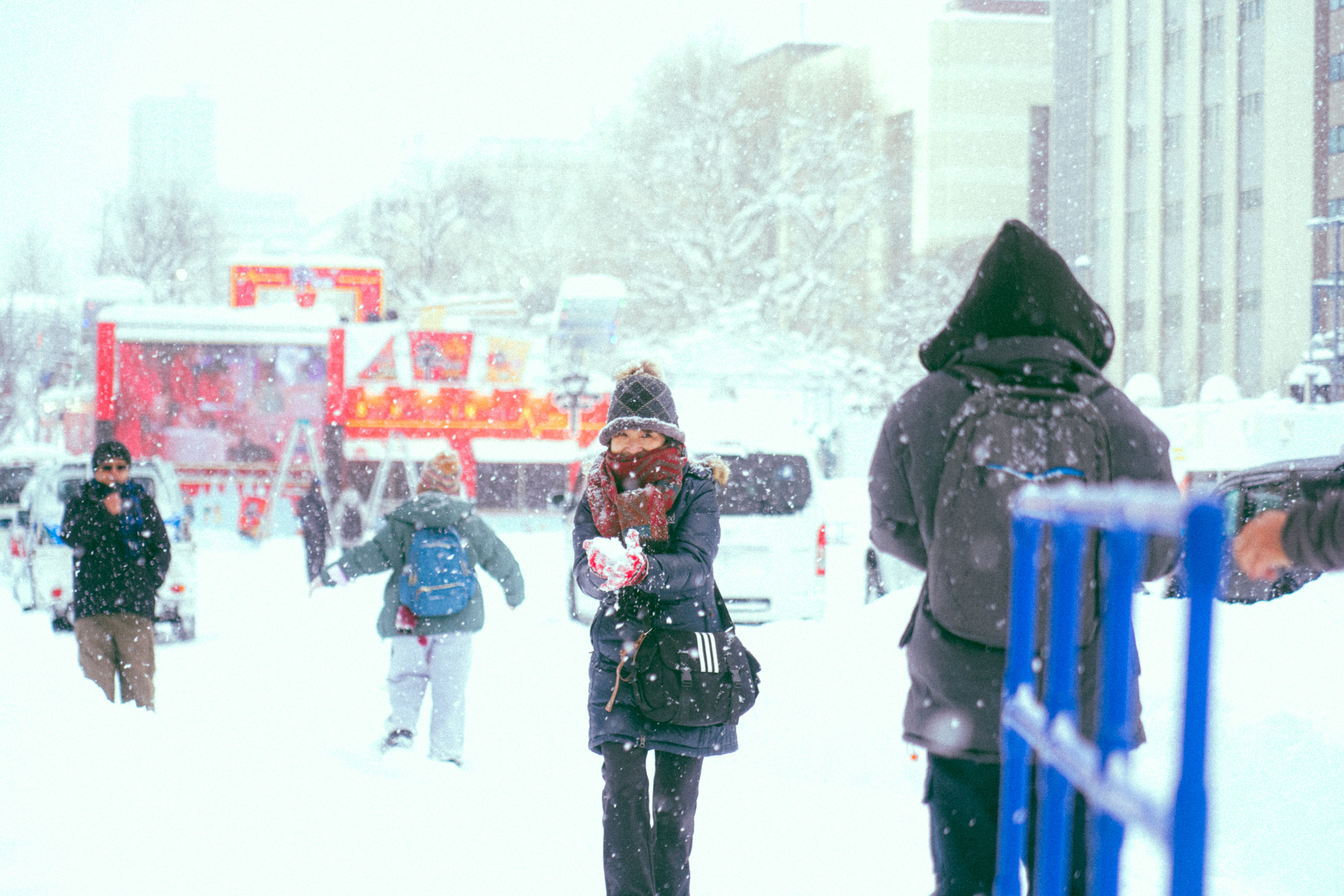 Visitors walking freely along the snow sculpture avenue in Odori Park in daylight with no gates or ticket barriers