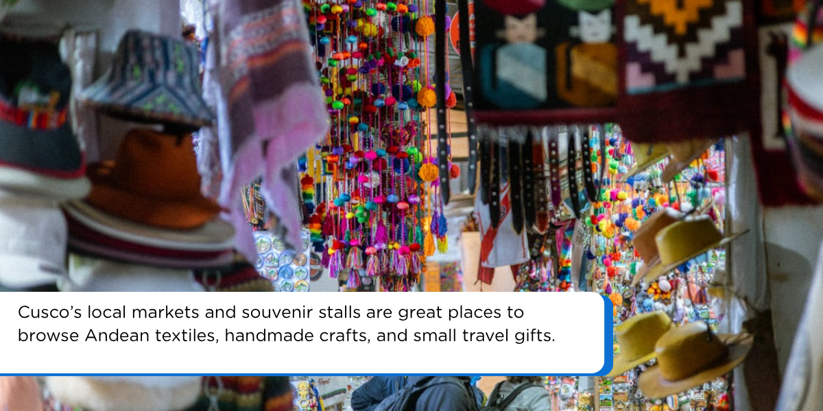Colorful souvenir market in Cusco Peru with Andean textiles, hats, handmade crafts, and travelers browsing local stalls