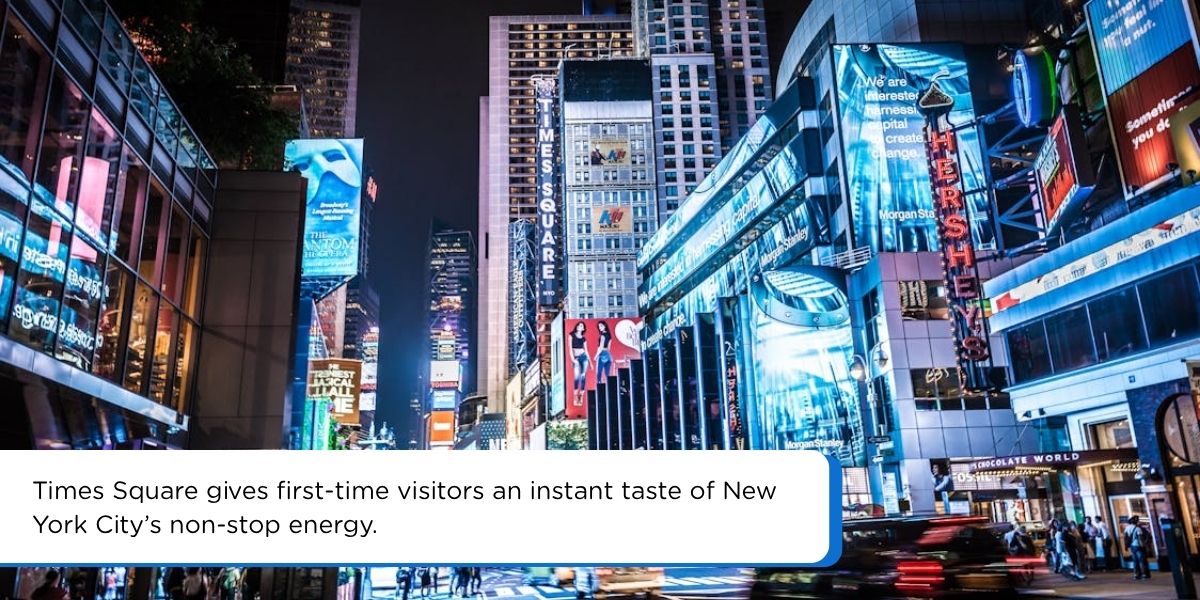 Times Square at night with bright billboards and crowds, a must-see in New York City for first-time visitors