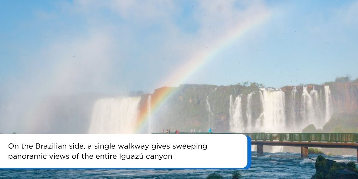 Panoramic view of Iguazu Falls from the Brazilian side with rainbow over the canyon