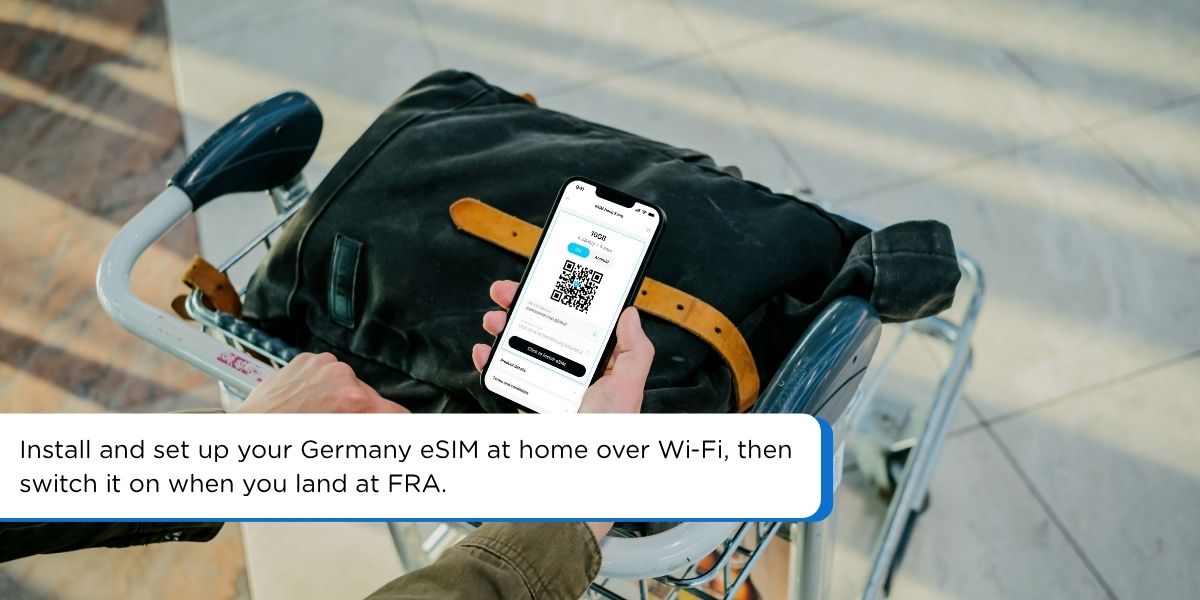  Traveler holding a smartphone to install a Germany travel eSIM before a flight to Frankfurt