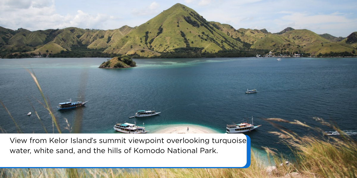 Kelor Island summit viewpoint with white sand beach, turquoise water, boats, and green hills near Labuan Bajo Indonesia