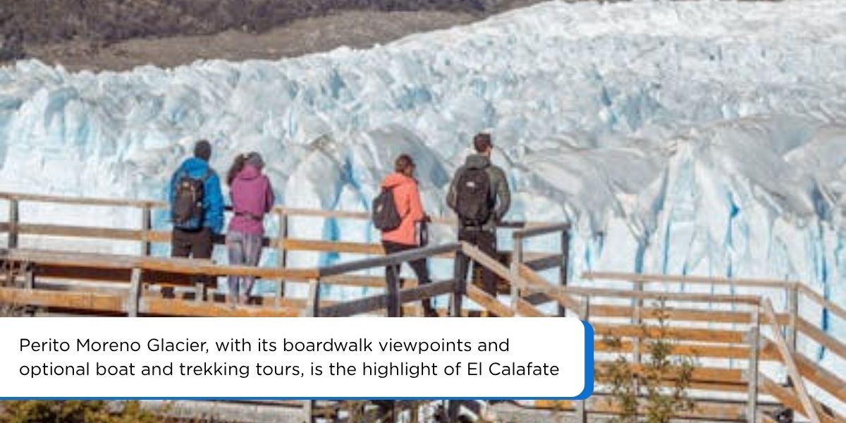 Tourists standing on a boardwalk facing the blue ice wall of Perito Moreno Glacier in Argentina