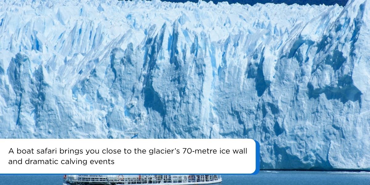 Boat approaching the towering ice wall of Perito Moreno Glacier on Lago Argentino