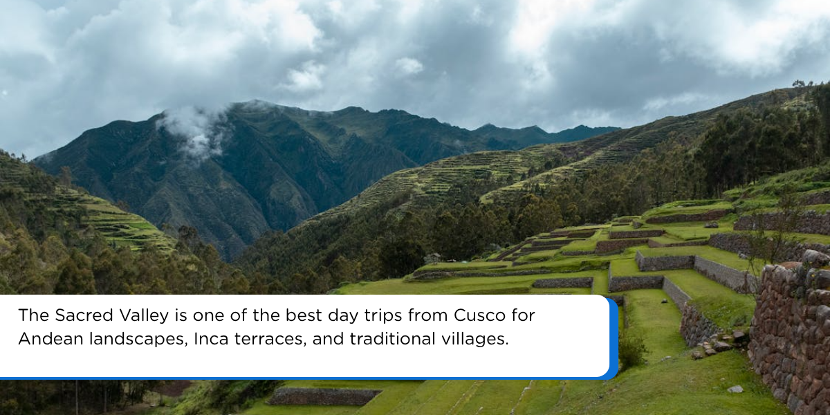 Sacred Valley day trip from Cusco Peru with green Inca terraces, stone walls, Andean mountains, and cloudy sky