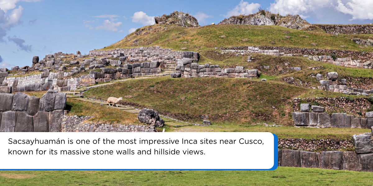 Sacsayhuamán Inca ruins near Cusco Peru with massive stone walls, grassy terraces, and Andean hillside scenery