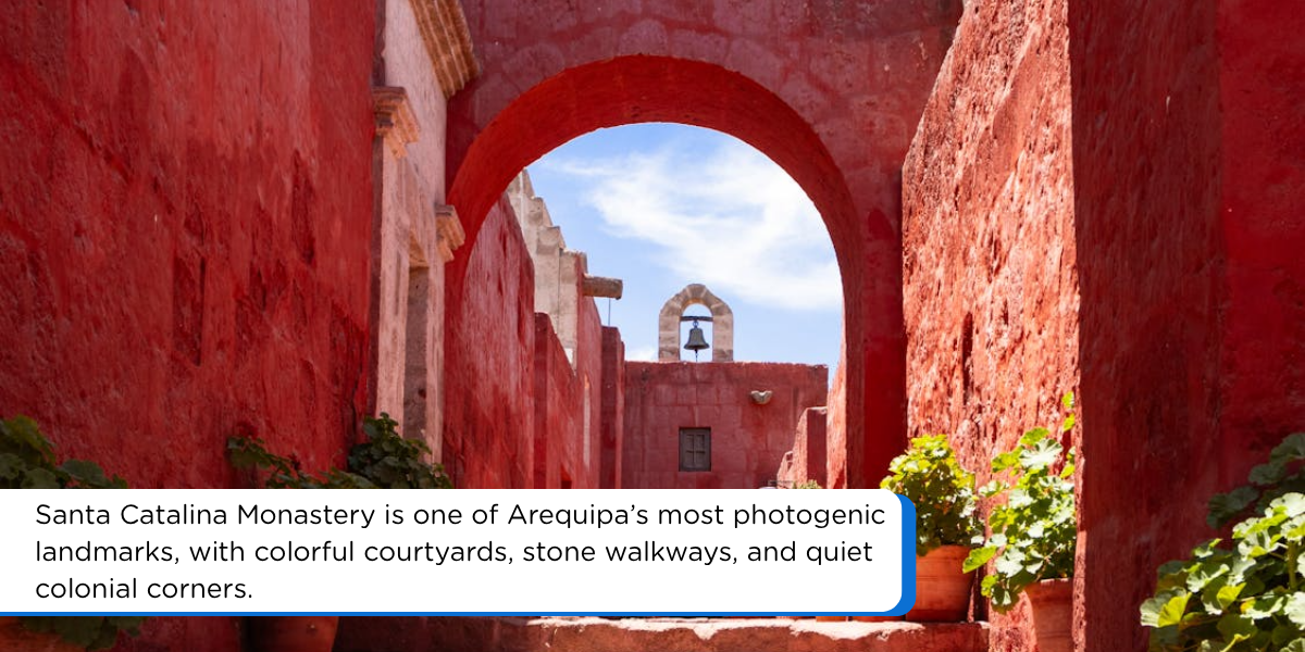 Santa Catalina Monastery in Arequipa Peru with red colonial walls, stone steps, arches, and potted plants