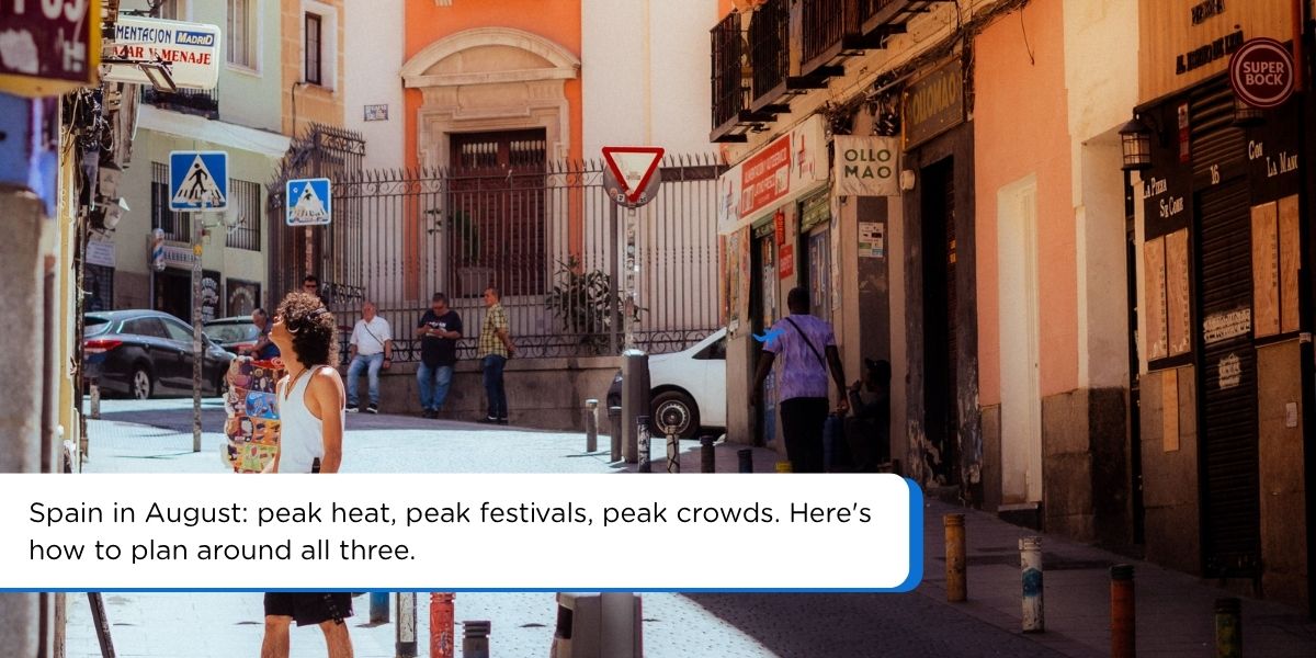 Sunny street scene in Spain in August with travelers exploring during peak summer season