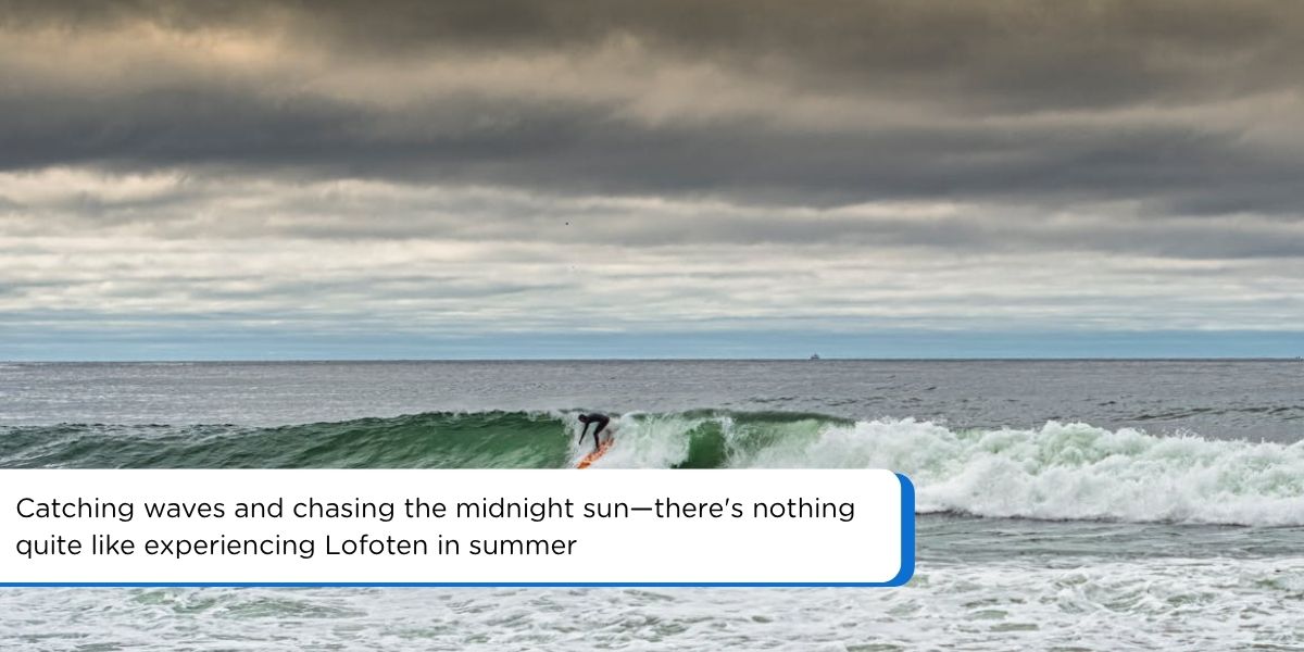 A surfer catching a wave at Unstad Beach during Lofoten in summer, under dramatic cloudy skies in Norway.