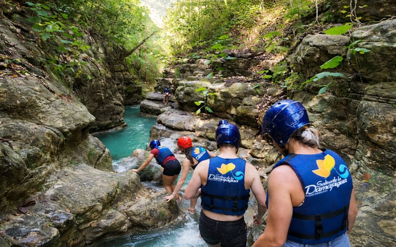 Travelers hiking between cascades at Damajagua Waterfalls near Puerto Plata