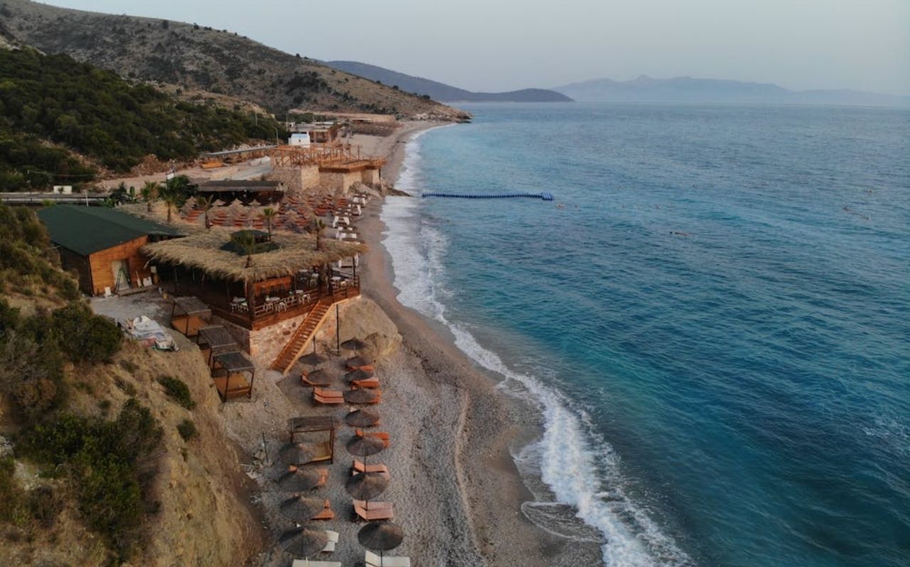 Dhermi Beach surrounded by cliffs and deep blue water along the Albania Riviera