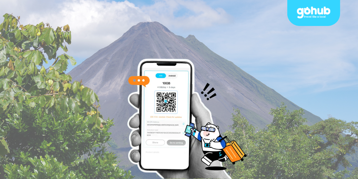 Traveler using Gohub eSIM app with QR code in front of Arenal Volcano in Costa Rica