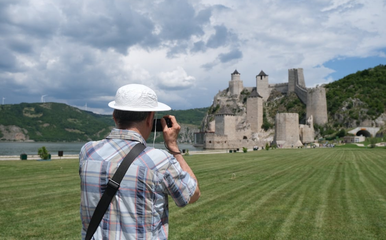 Traveler photographing Golubac Fortress along the Danube River in eastern Serbia