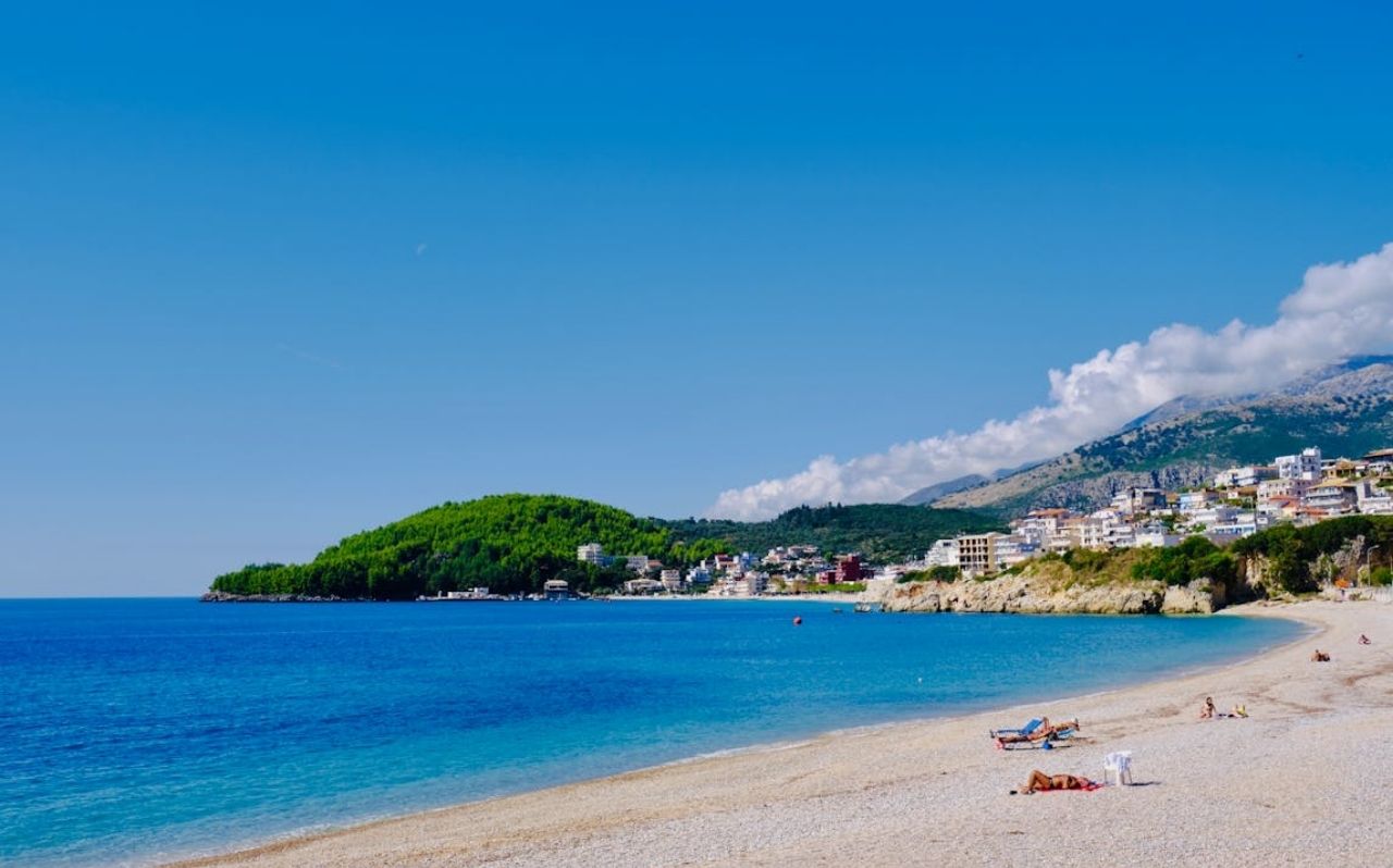 Himare beach town with clear water and hillside houses on the Albanian coast