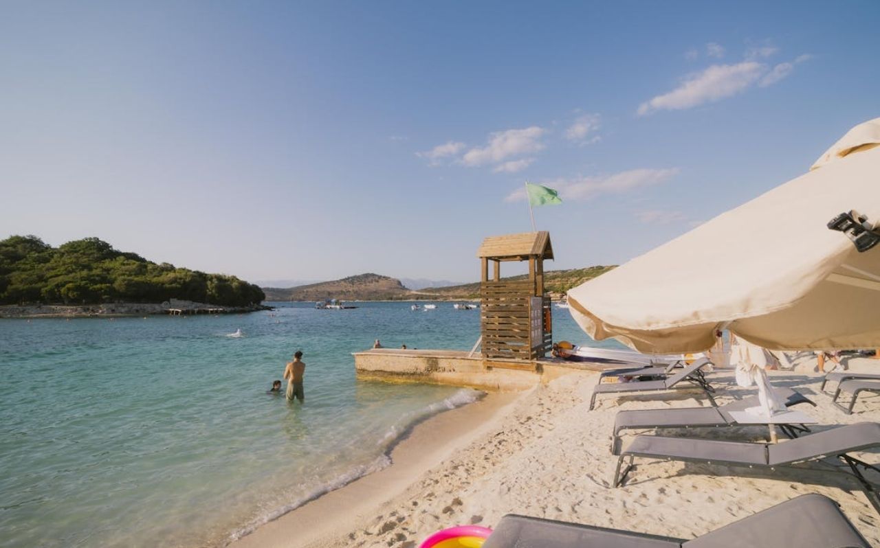 Ksamil Beach in southern Albania with shallow turquoise water and small offshore islands