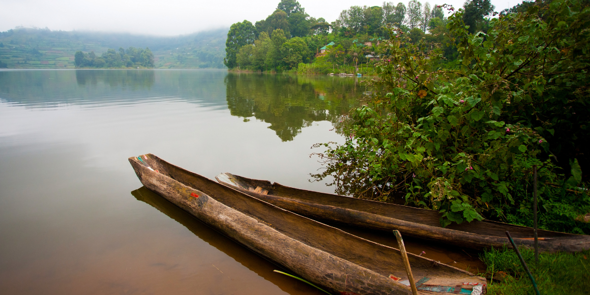 Traditional dugout canoes resting on the calm shores of Lake Bunyonyi in Uganda’s highlands