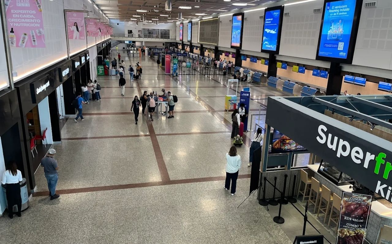 Traveler checking navigation on smartphone at Las Américas Airport Santo Domingo