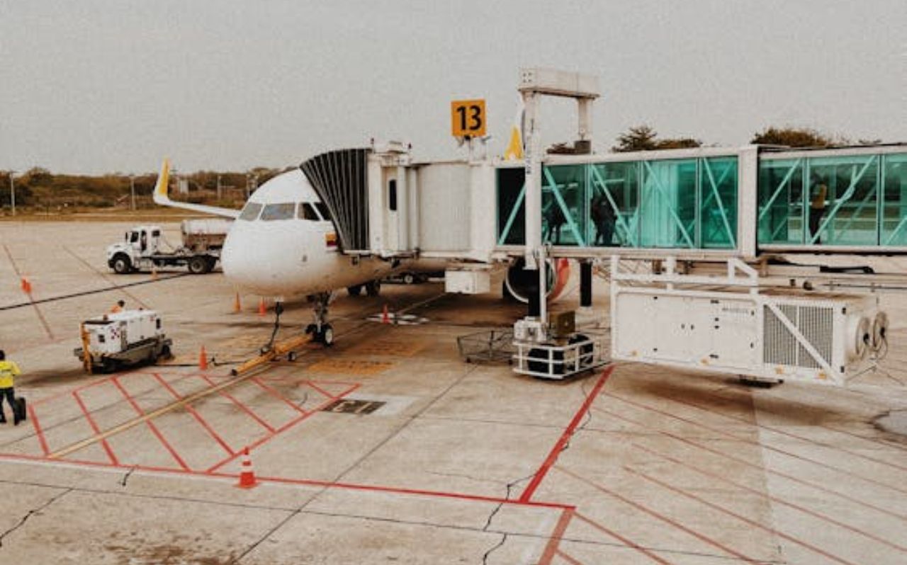 Travelers checking directions on a smartphone after arriving at Medellín airport