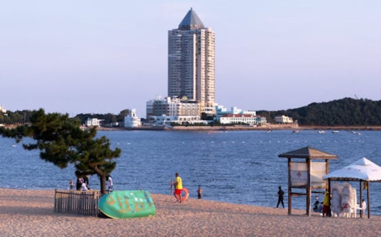 Urban waterfront beach in Okinawa with high-rise building in the background