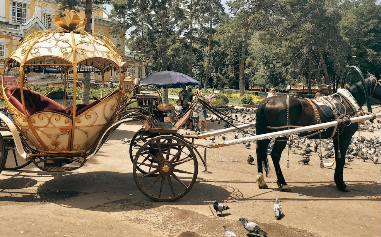 Panfilov Park in Almaty with tree-lined paths and people walking