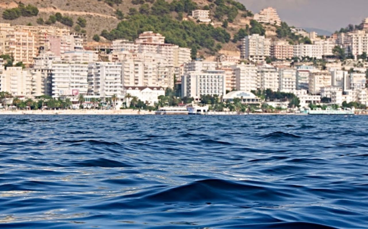 Saranda waterfront promenade with coastal buildings and marina in Albania
