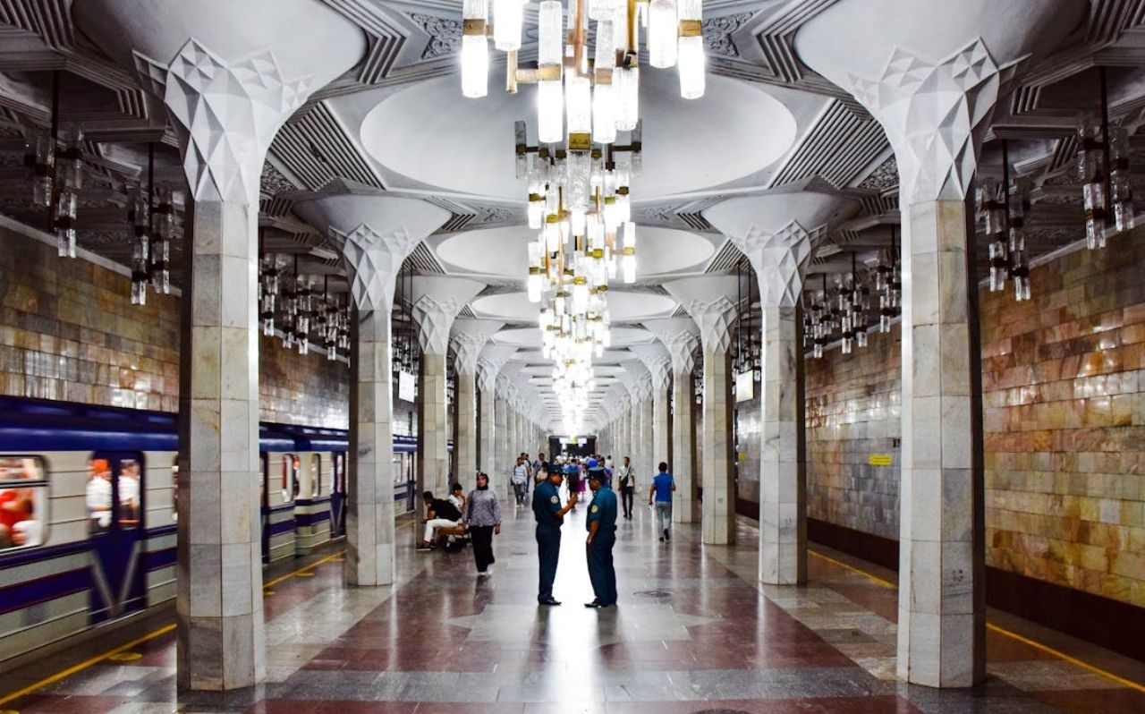 Decorative interior of Tashkent Metro station with chandeliers and patterned ceilings