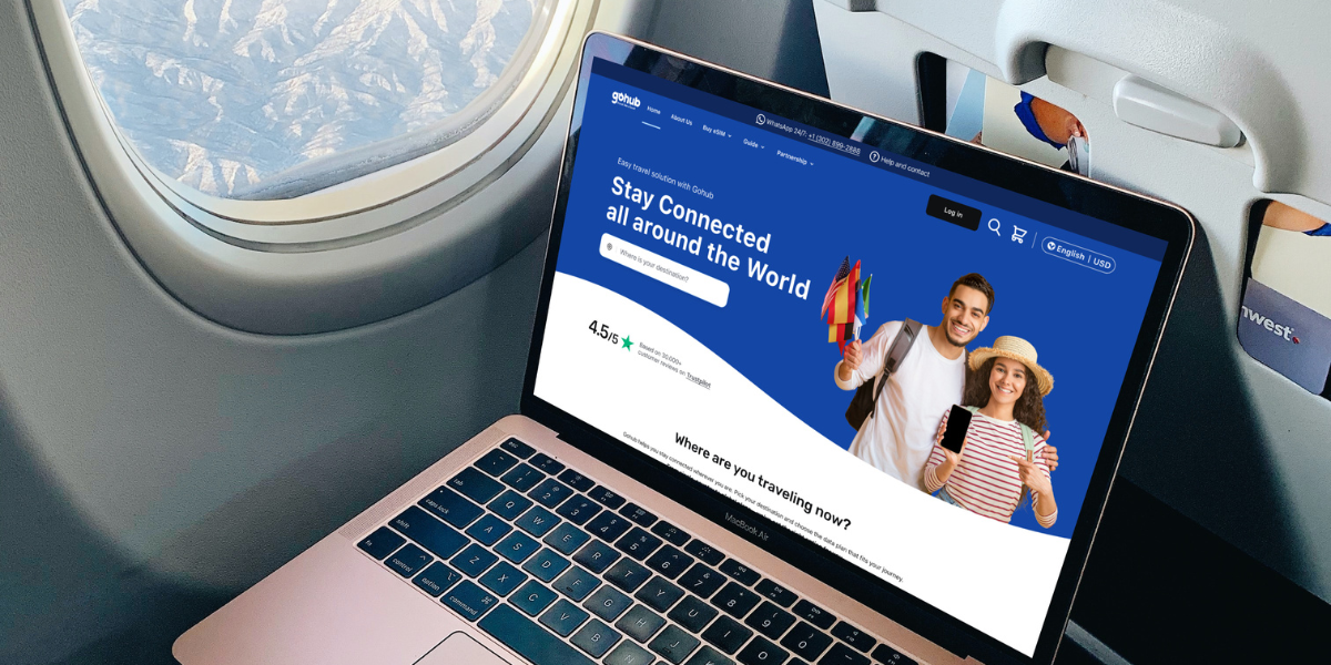 Traveler using GOHUB eSIM website on laptop during a flight