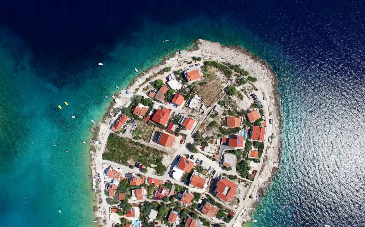 Aerial view of Zlatni Rat beach on Brač Island Croatia with turquoise Adriatic water and red-roofed houses